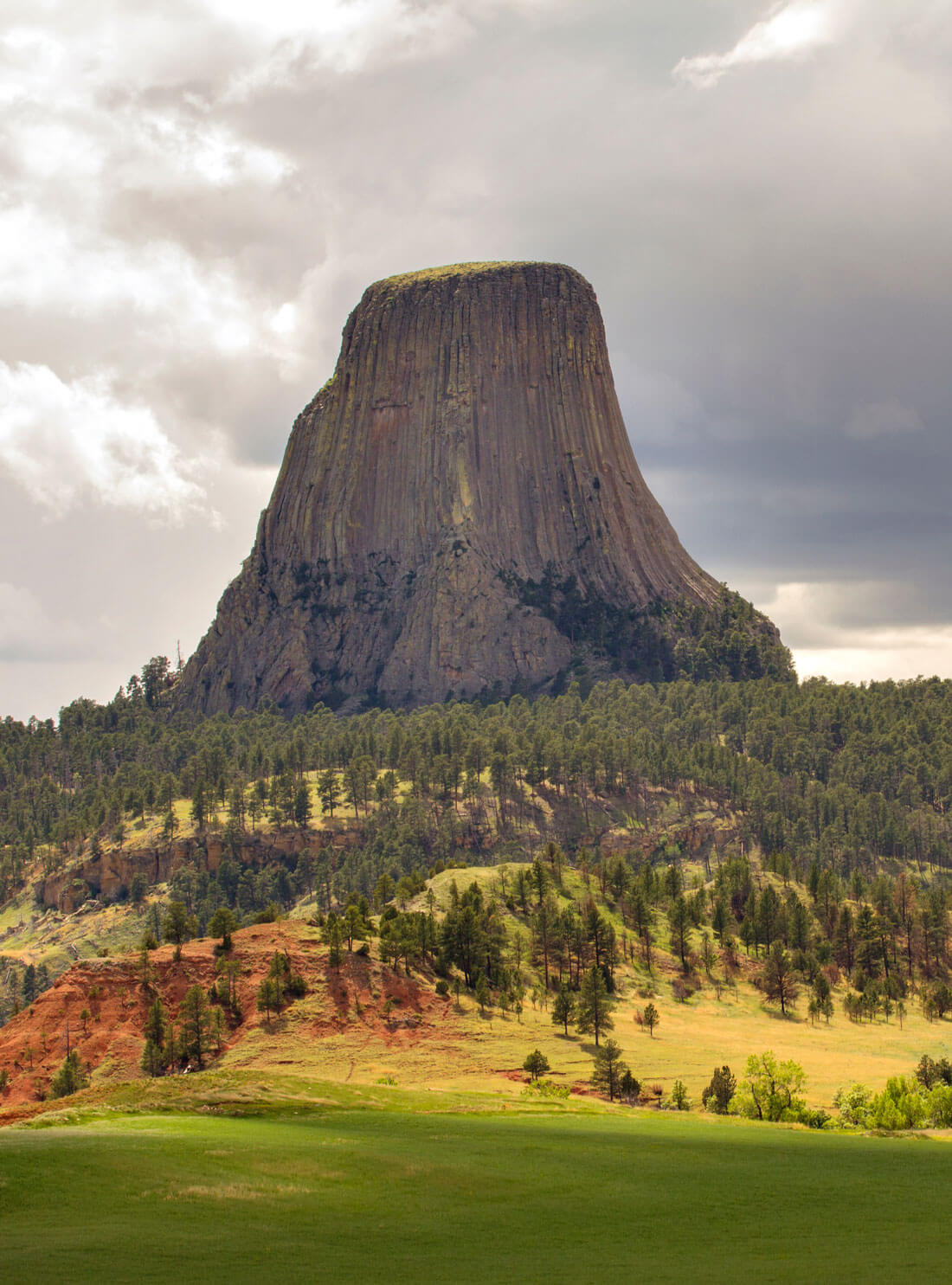 Scenic View Of Rock Formation Against Cloudy Sky