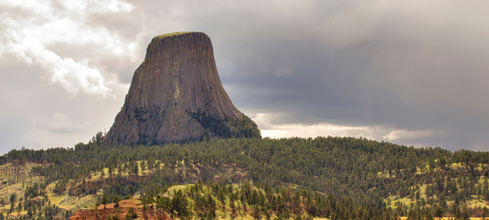 Scenic View Of Rock Formation Against Cloudy Sky